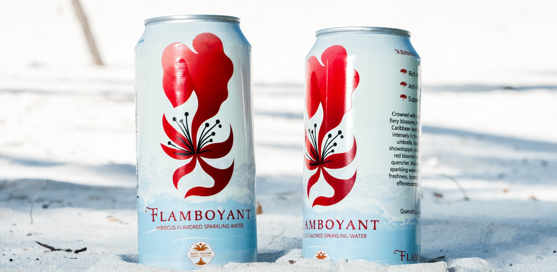 Flamboyant hibiscus sparkling water cans on white sand